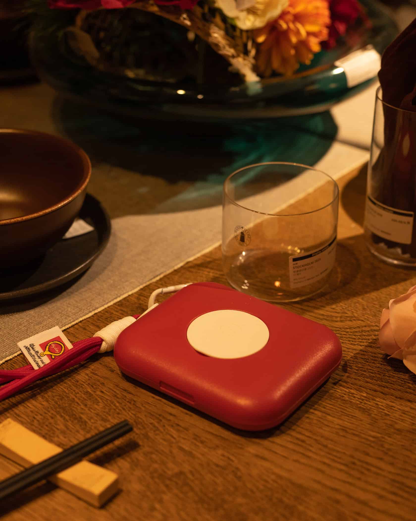 Portable health device from Muyocare × Eraecho on a wooden table for wellness tracking.